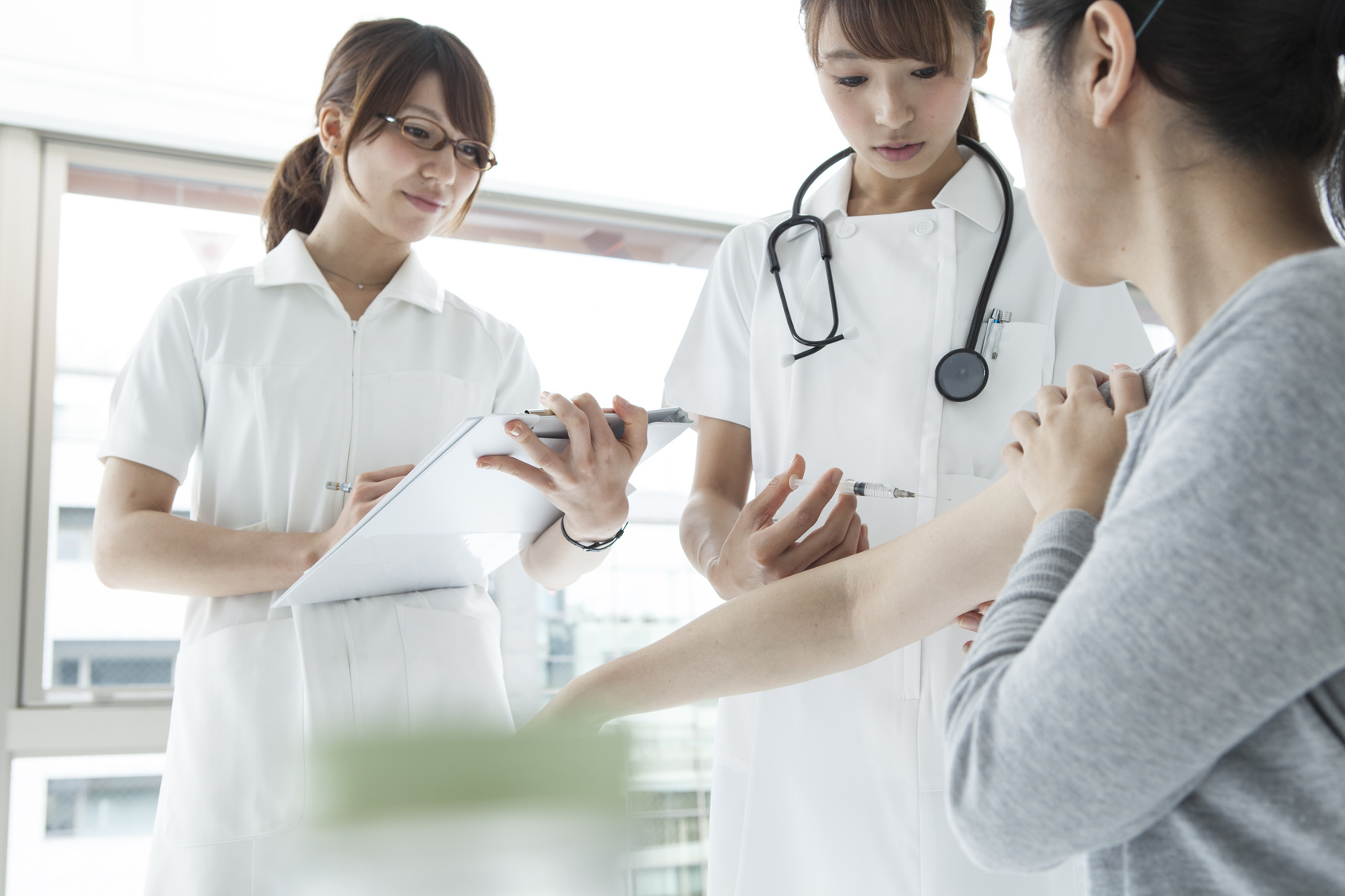 Nurses have an injection into a patient